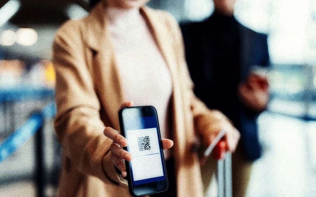 Female passenger presenting a QR code on a mobile phone for a verifiable credential.